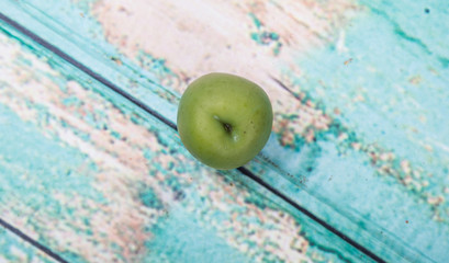 Pickled green olives over wooden background