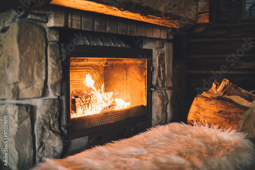 Warm cozy fireplace with real wood burning in it Poster Mural XXL