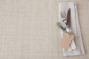 Wall Mural - Table place setting with rosemary and empty tag, holidays copy space, selective focus, vintage tone