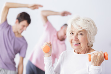 Canvas Print - Senior woman with dumbbells