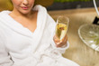 © Syda Productions - close up of young woman drinking champagne at spa