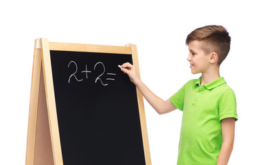 Wall Mural - happy boy solving math on school blackboard