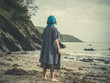 © LoloStock - Young barefoot woman with headscarf on beach