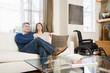 © xixinxing - Couple relaxing in the living room