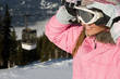 © xixinxing - woman holding a ski mask