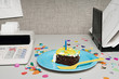 © xixinxing - Birthday cake on an office desk