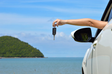 Driver woman happy showing car keys out window