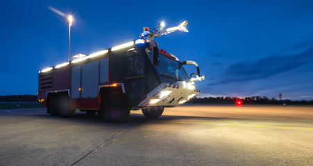 Wall Mural - airport fire truck in the evening