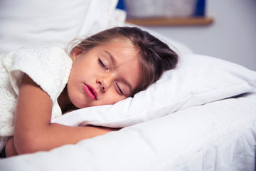 little girl sleeping in bed