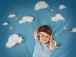 boy lying on blanket with white clouds