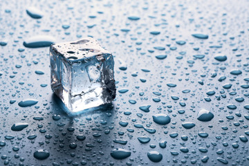 Canvas Print - Clear melting ice cube with drops around, close up