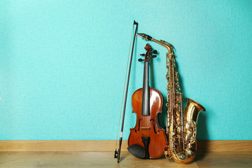 Sticker - Violin and saxophone on the floor against blue background