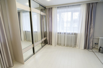 interior of living room with window and mirror wardrobe