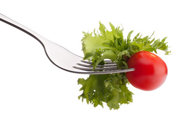 Fresh salad and cherry tomato on fork isolated on white backgrou