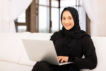 Wall Mural - muslim woman using laptop