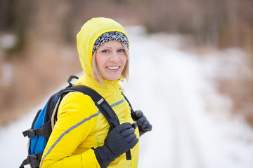 Wall Mural - Woman hiking and walking in winter woods