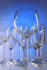 Poster - Empty wine glasses on blue background