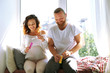© Africa Studio - Happy beloved couple blow soap bubbles in waiting for baby's birth on window board
