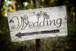 Rustic wedding arrow sign on a shovel.
