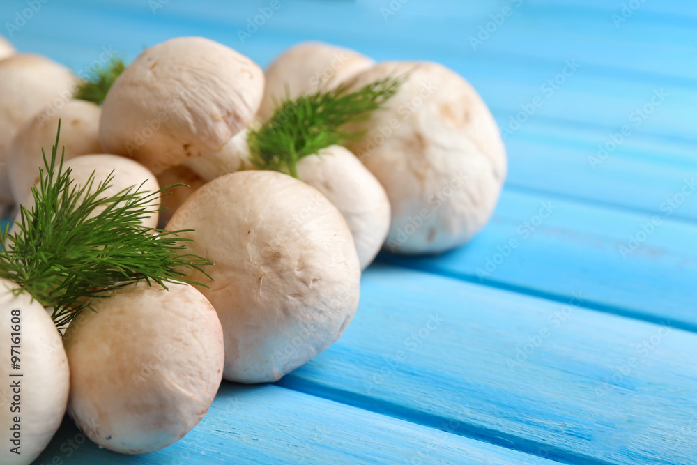 Mushrooms on color wooden surface
