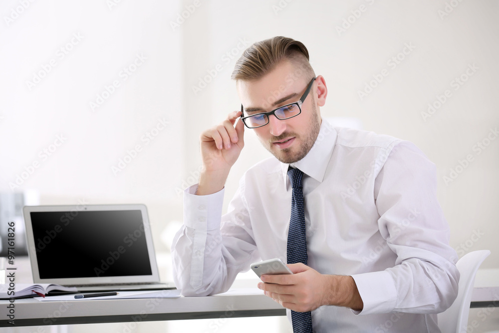 Businessman working with laptop in office