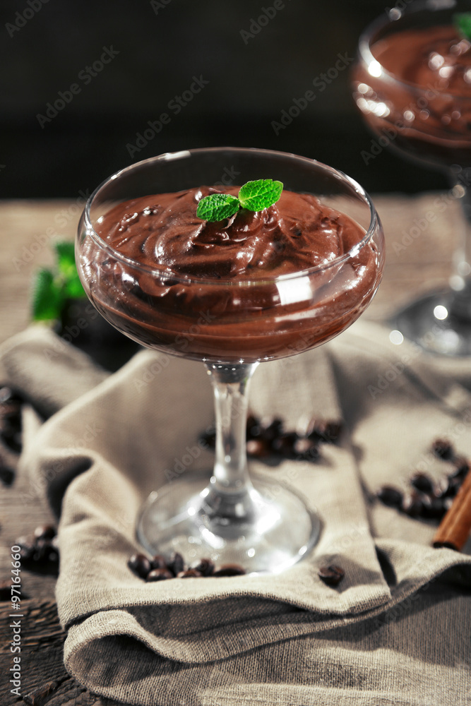 Chocolate dessert in glasses on wooden background