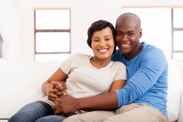 Wall Mural - african american couple sitting on sofa at home