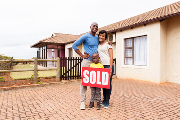 Wall Mural - young african family in front of their home