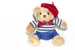 © nadezhdaabramian - Bear toy on a white background. Souvenir toy bear in a beret and tie.