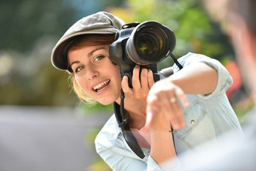 Young woman photographer doing a photoshoot with model