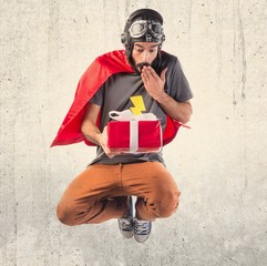 Wall Mural - Superhero holding a gift