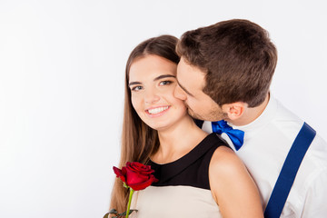 Canvas Print - Cute young man kissing his girlfriend with a rose