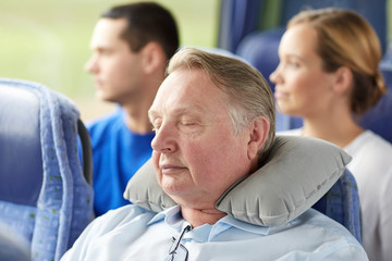 Poster - senior man sleeping in travel bus with neck pillow