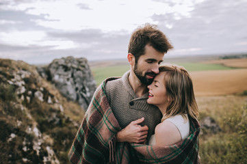 beautiful young couple on a background of rock cliff