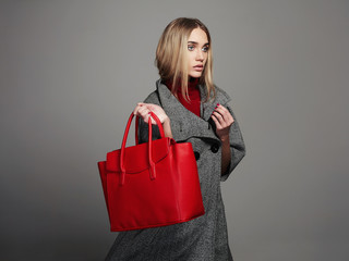 Wall Mural - winter beautiful woman with handbag.fashion girl in topcoat.shopping
