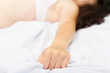 © volkovslava - Female hand pulling white sheets in ecstasy
