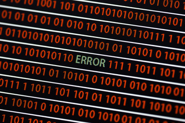 Wall Mural - an error message in the screen. the error text is in green and zeros and ones are in red. image take