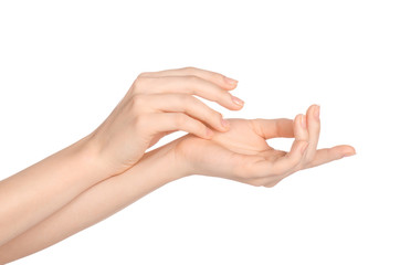 Wall Mural - Beauty and Health theme: beautiful elegant female hand isolated on a white background in the studio, using cream advertisement, massage