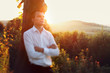 Handsome galant groom in stylish shirt posing at sunset, with hi