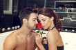 Sexy couple smell rose in jacuzzi