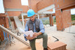 © goodluz - Construction manager checking blueprint on site