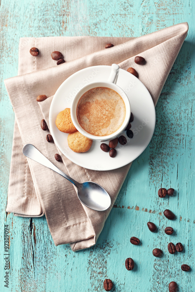 Cup of coffee on color wooden background