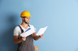 © Africa Studio - Young worker renewing apartment on wall background