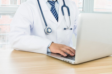 Doctors using laptop at work