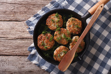 Fish Cakes With Herbs In A Frying Pan. Horizontal Top View

