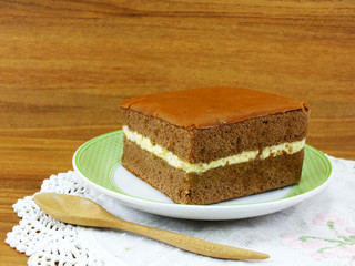 Sticker - delicious soft cake chocolate flavor with cup of tea on wooden table