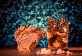 faded leaf and splash in glass