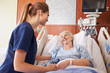 © Monkey Business - Nurse Talking To Senior Female Patient In Hospital Bed