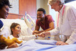 Pediatrician Visiting Parents And Child In Hospital Bed