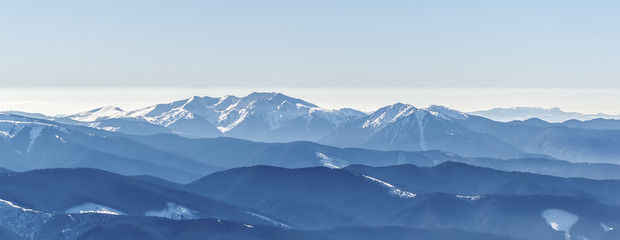 Distant sharp peaks. blue mountain ranges. Ukrainian Carpathian Mountains